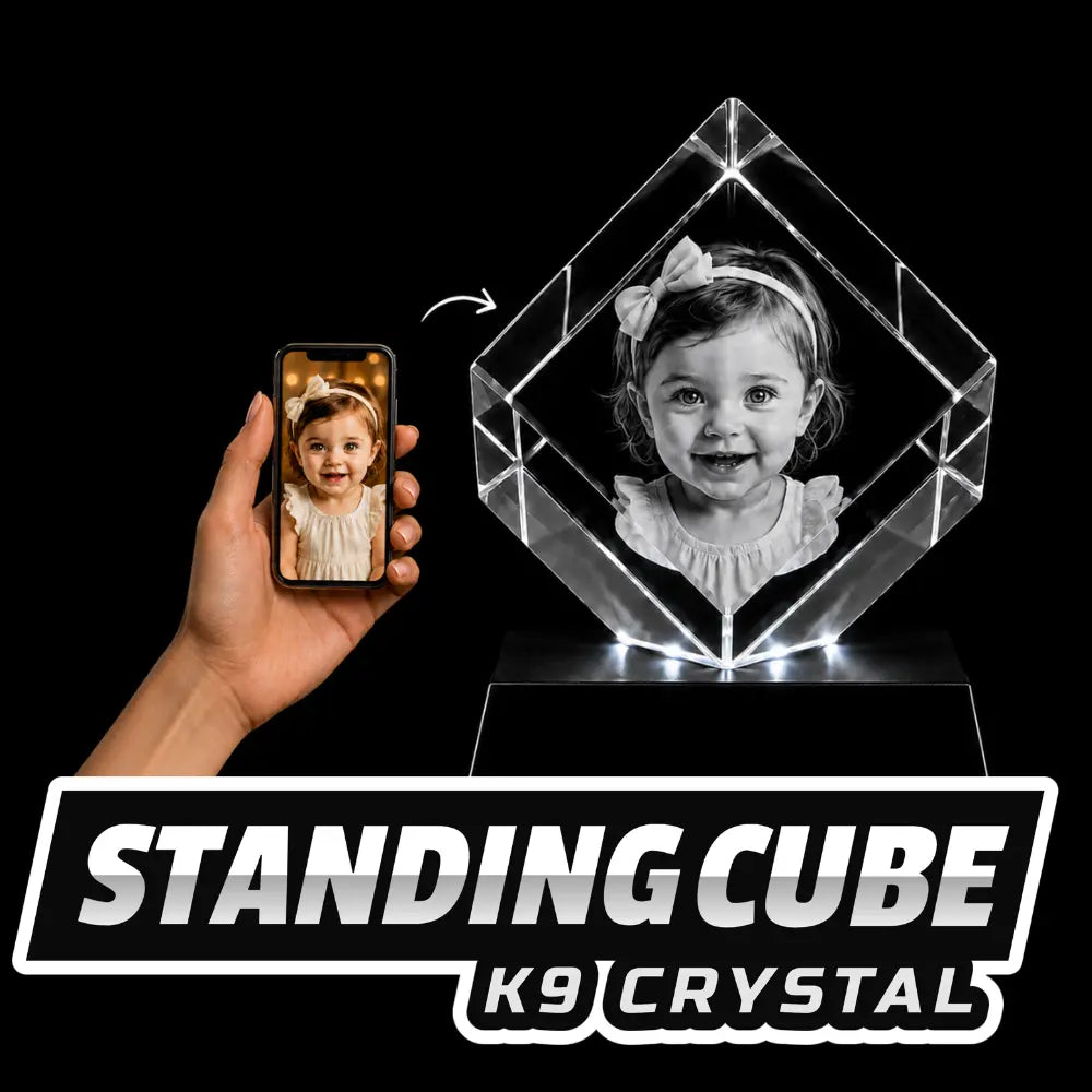 Custom standing cube K9 crystal with a laser-engraved 3D image of a smiling baby girl, shown with the original smartphone photo reference.